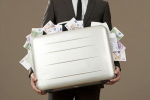 Businessman holding suitcase full of Euro notes